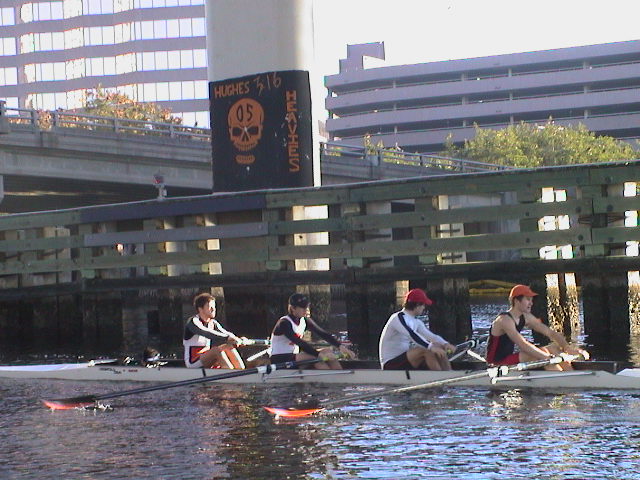 A group of people rowing a boat in the water