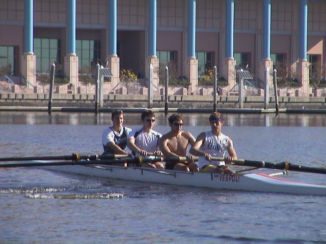 A group of people rowing a boat in the water