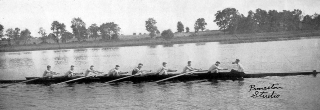 A group of people in a small boat in a body of water