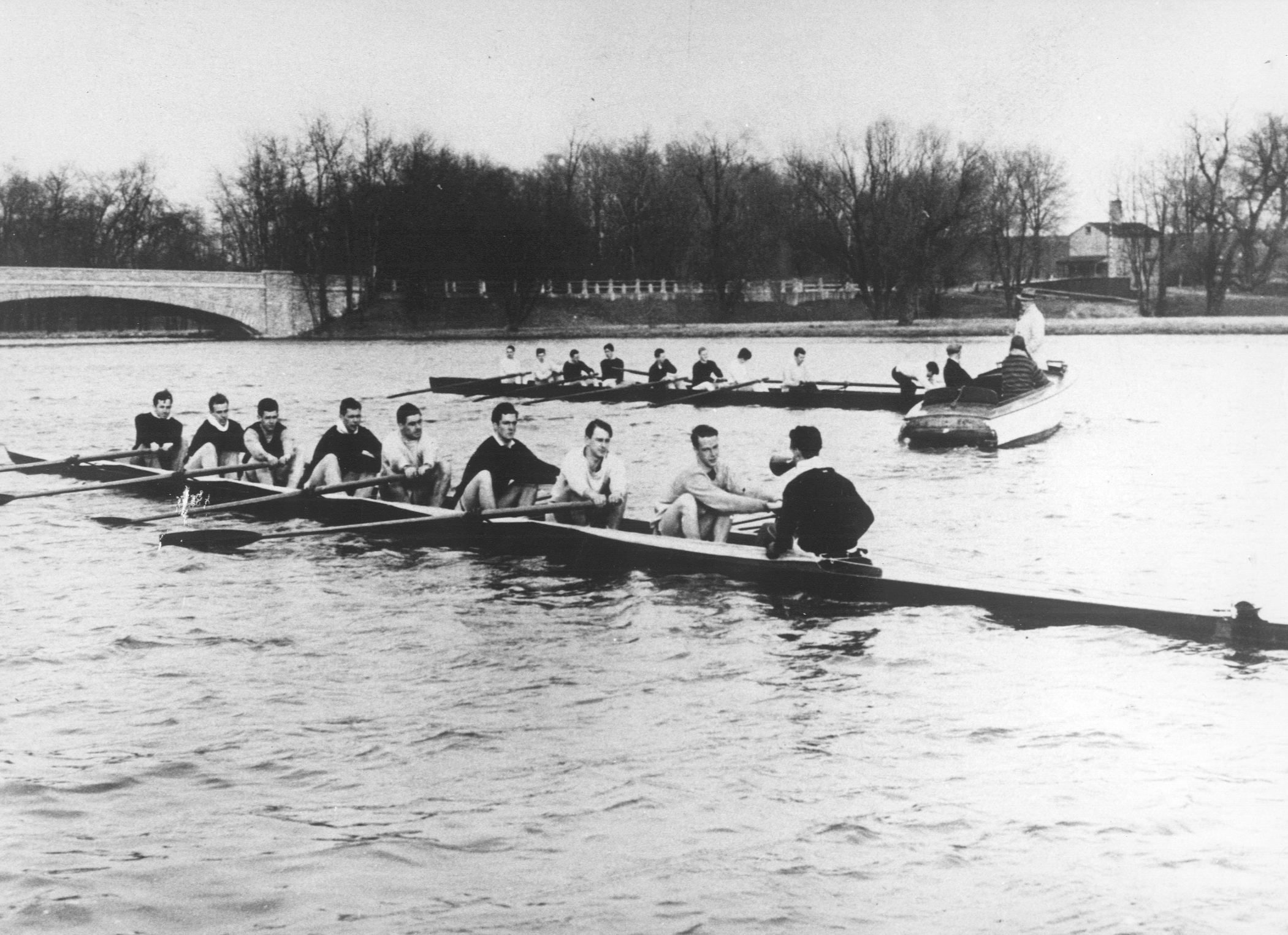 A group of people rowing a boat in a body of water
