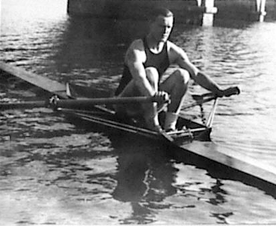 A man rowing a boat in a body of water