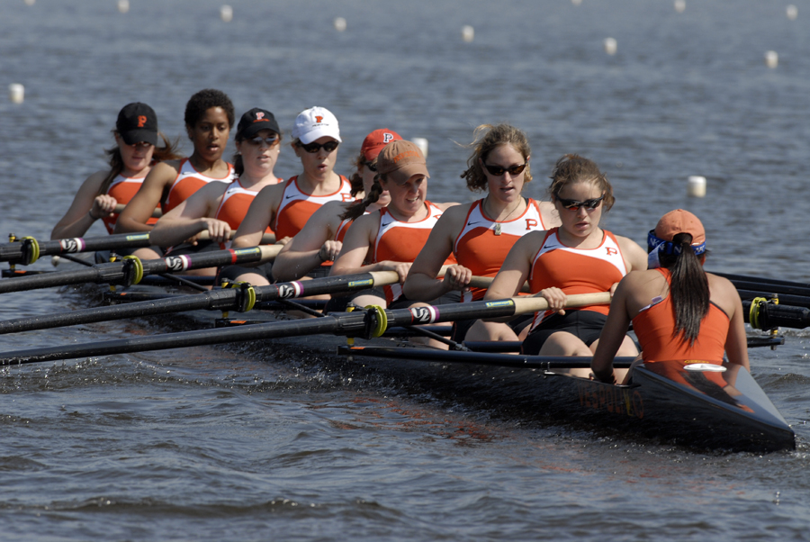 A group of people rowing a boat in the water