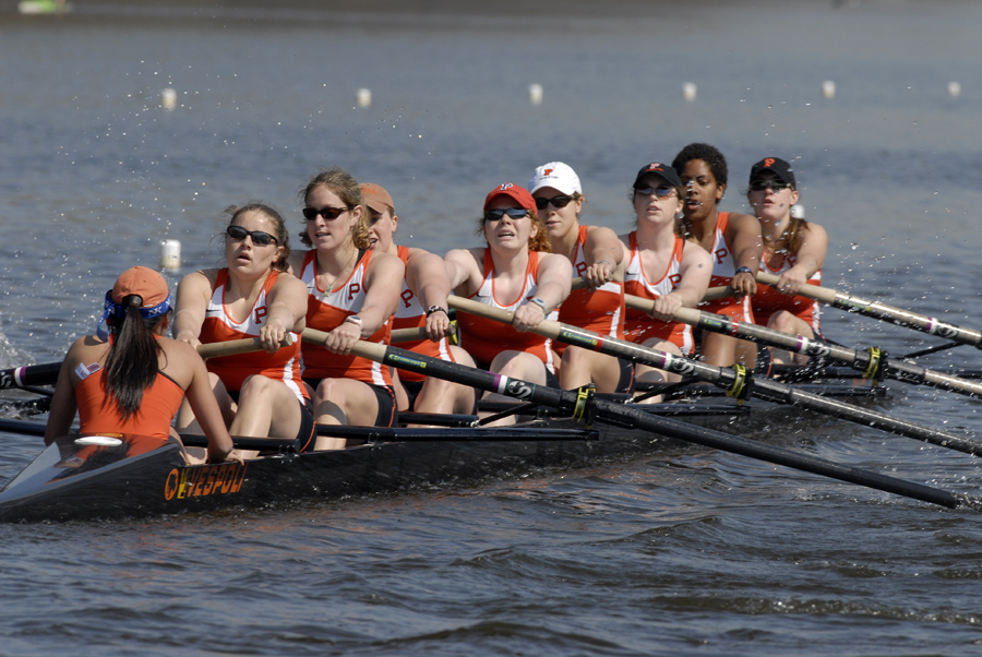 A group of people rowing a boat in the water