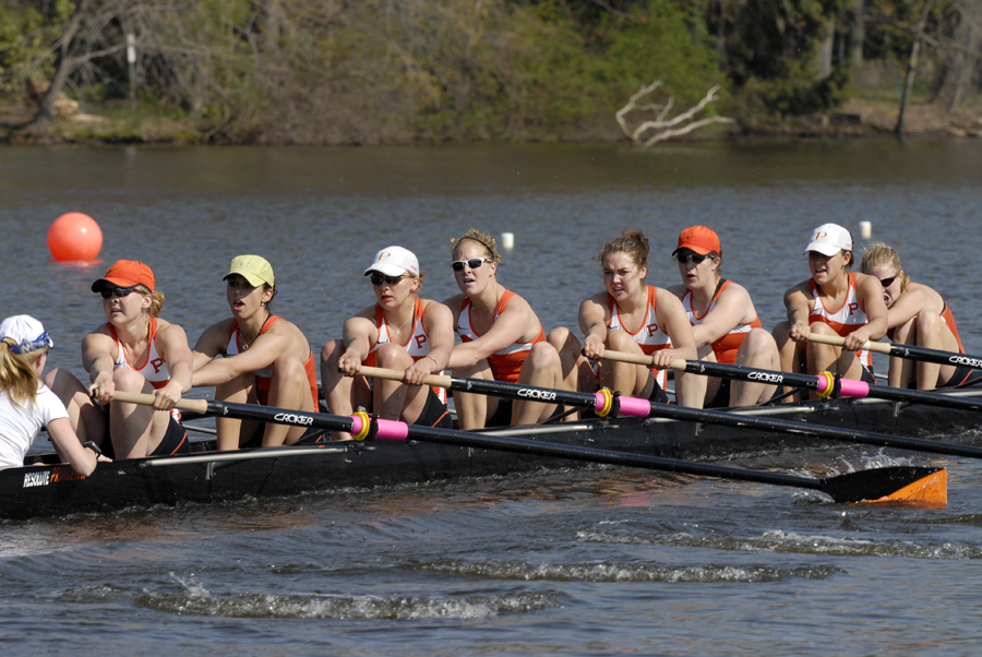 A group of people rowing a boat in the water