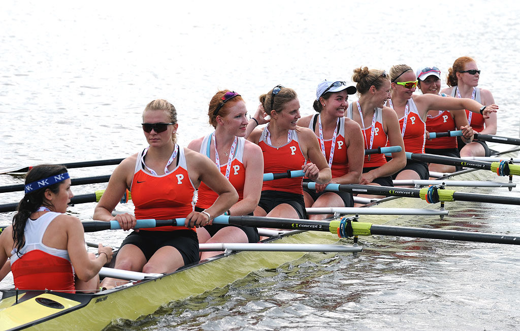 A group of people rowing a boat in the water