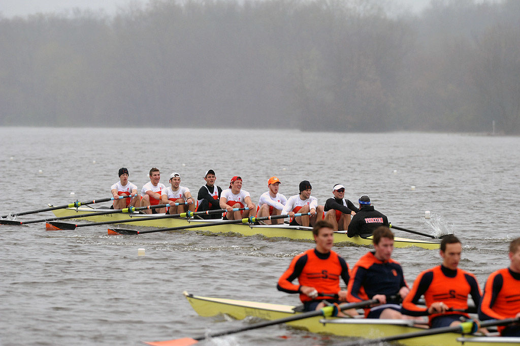 A group of people rowing a boat in the water