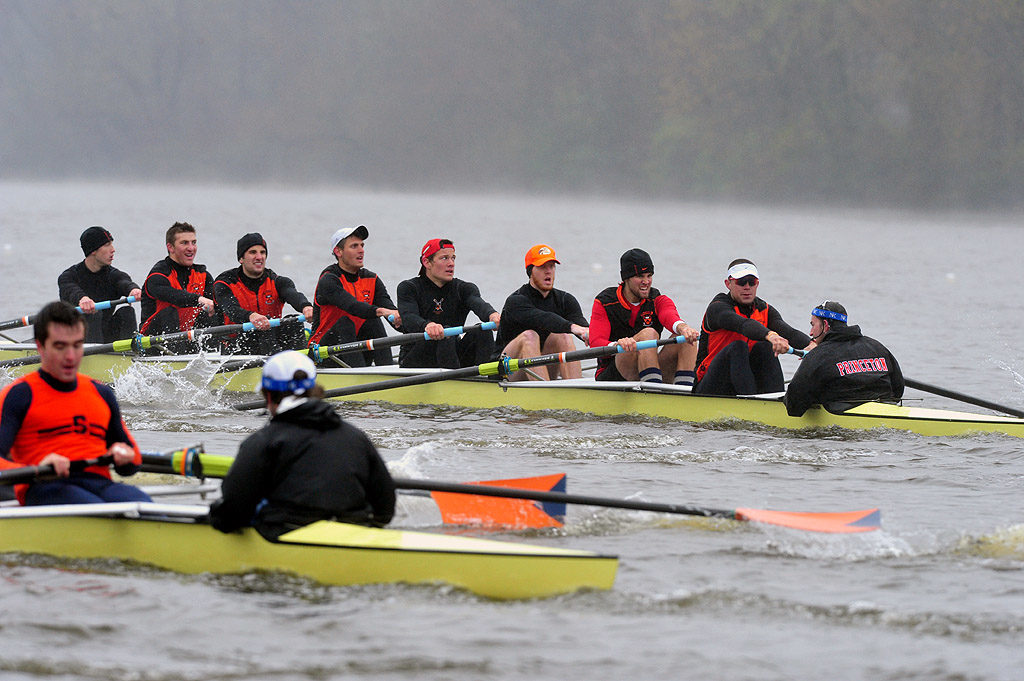 A group of people rowing a boat in the water