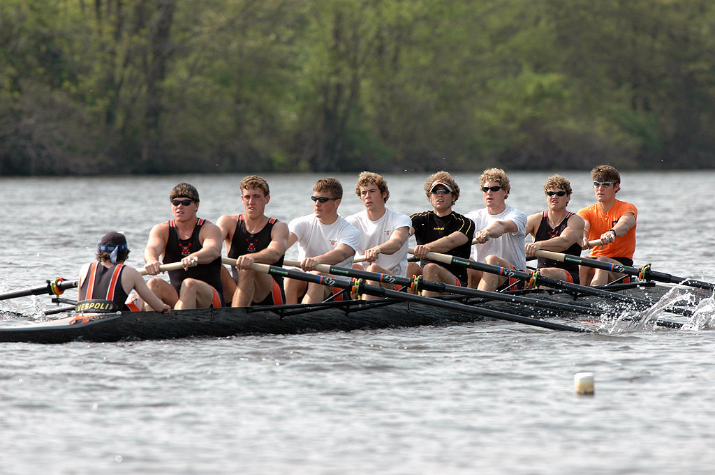 A group of people rowing a boat in the water