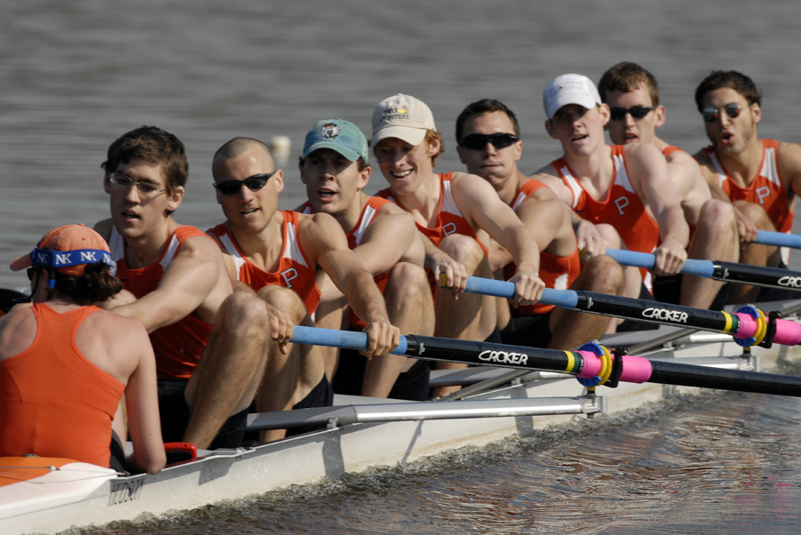 A group of people rowing a boat in the water