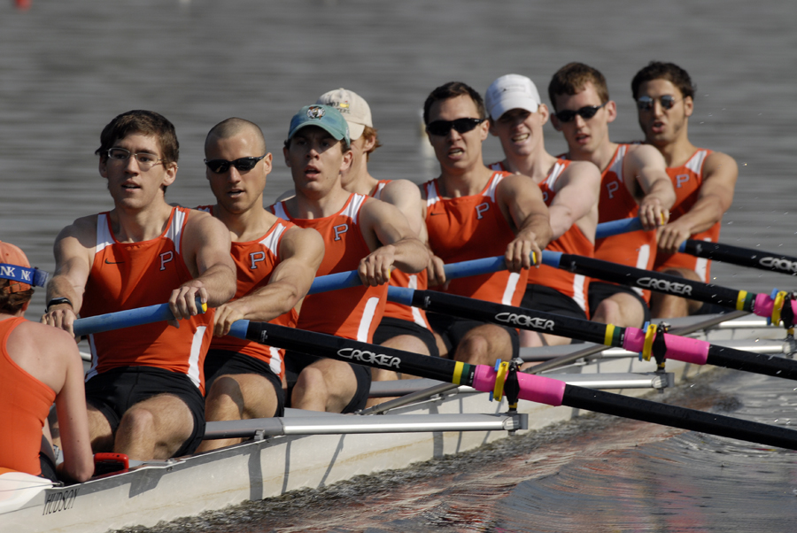 A group of people rowing a boat in the water