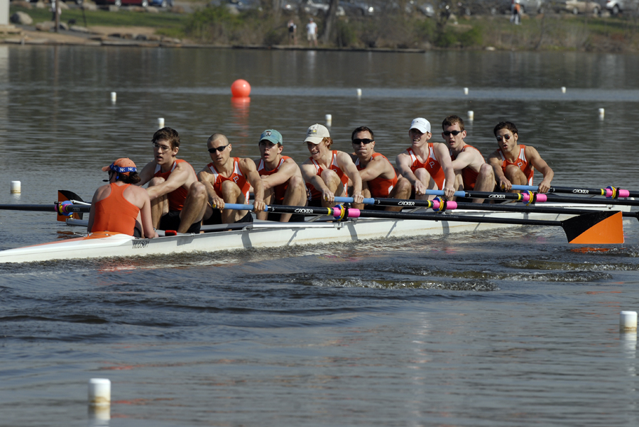 A group of people rowing a boat in the water