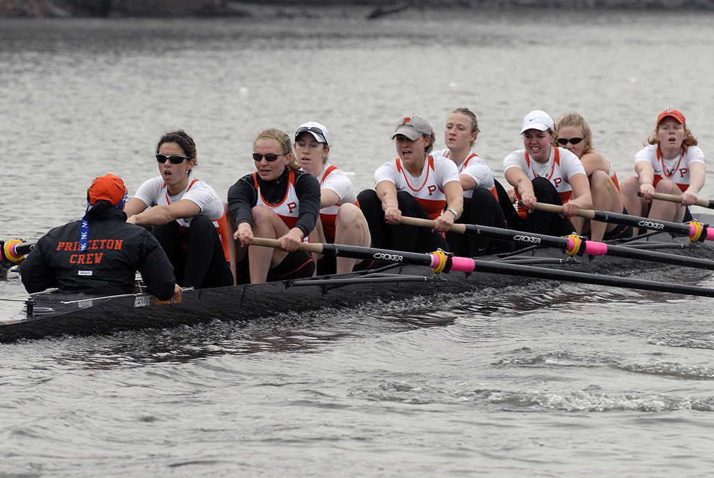 A group of people rowing a boat in the water