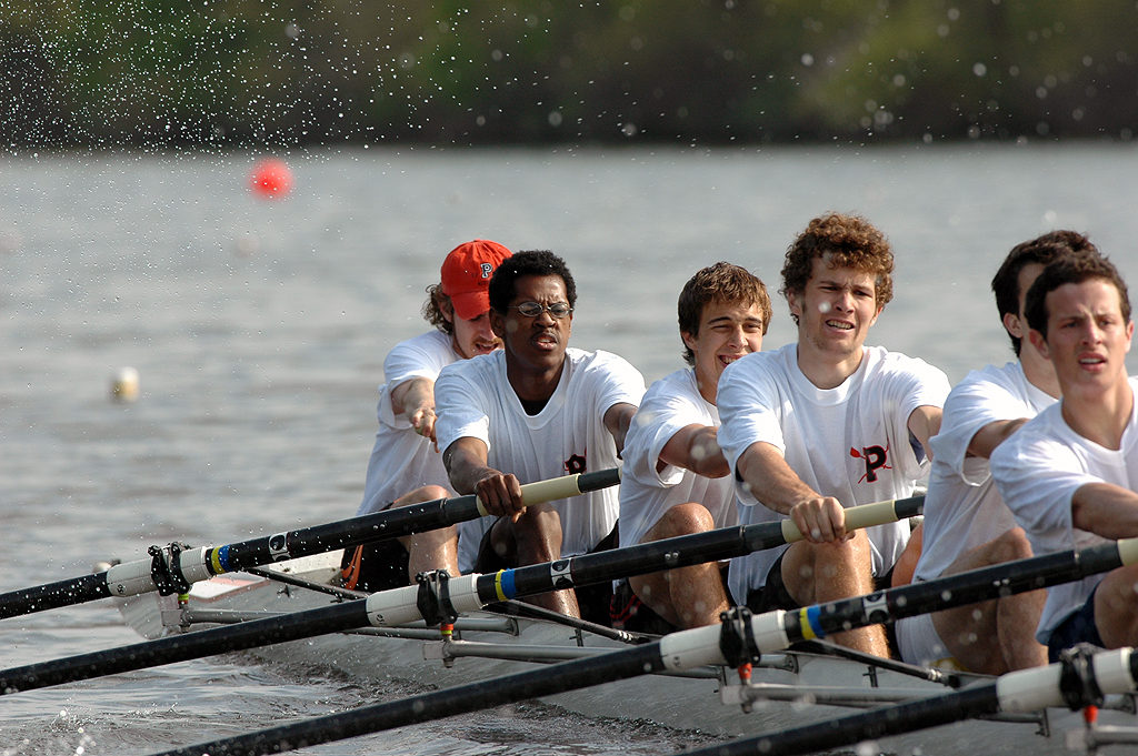 A group of people rowing a boat