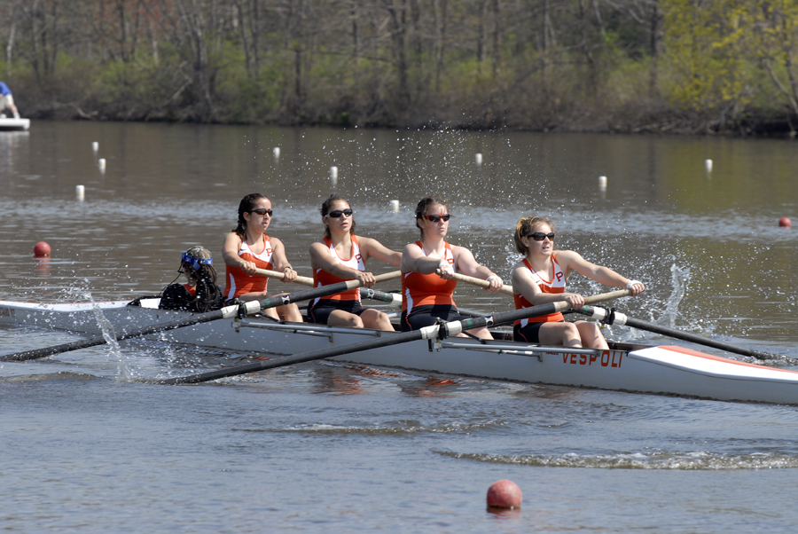 A group of people rowing a boat in the water