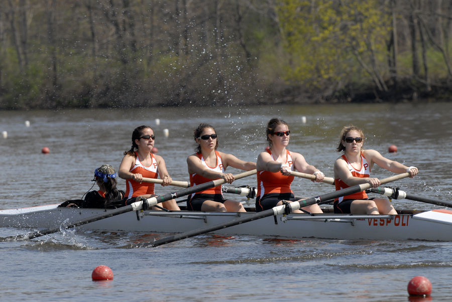 A group of people rowing a boat in the water