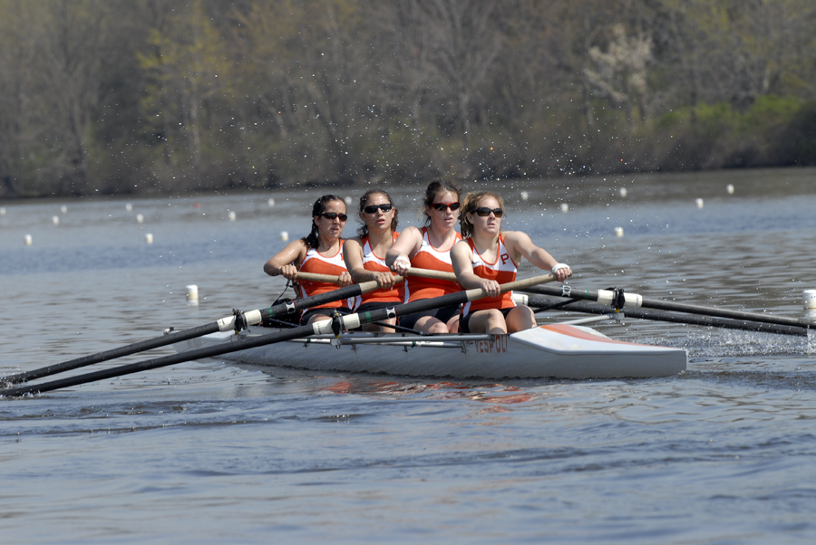 A group of people rowing a boat in the water