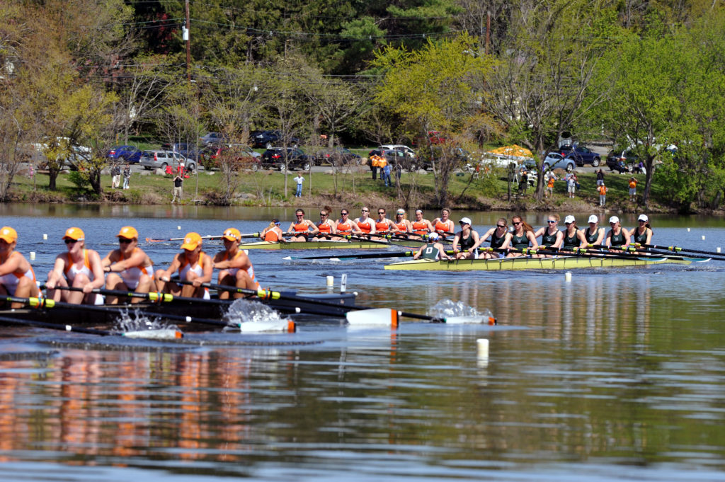 A group of people rowing a boat in the water