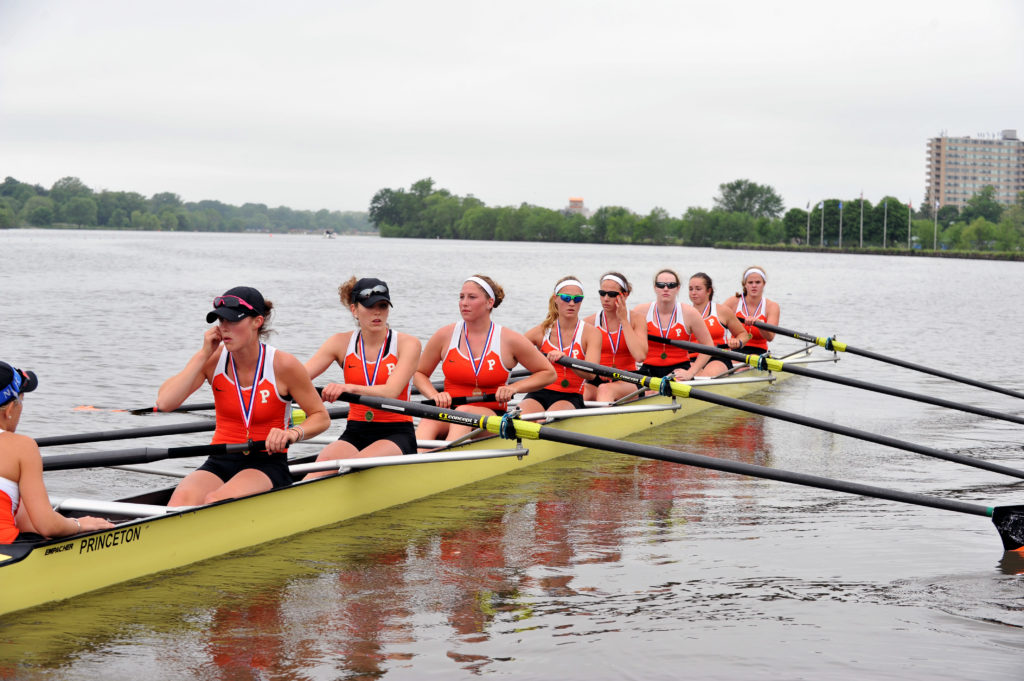 A group of people rowing a boat in the water