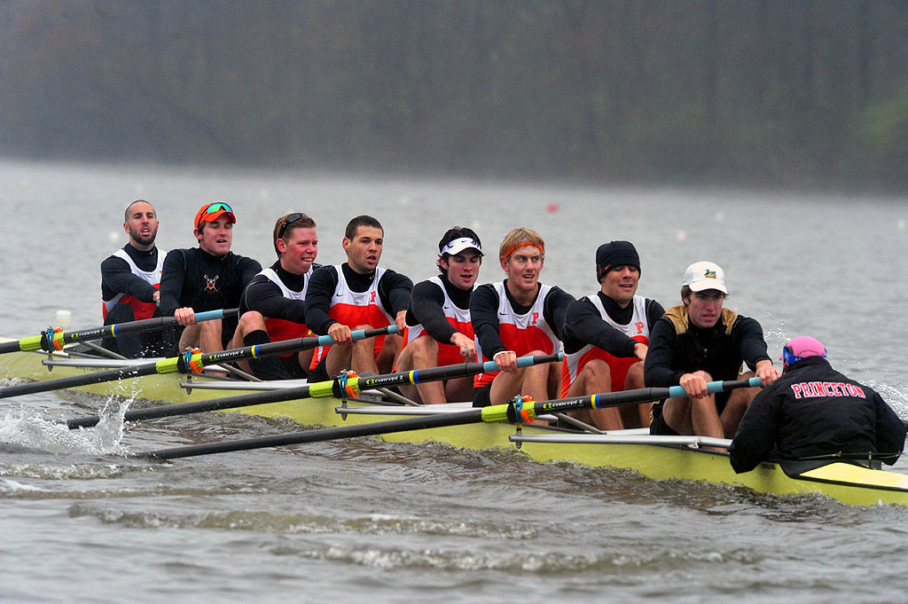 A group of people rowing a boat in the water