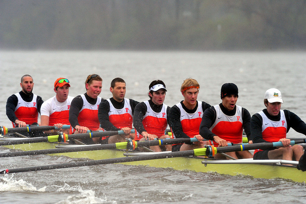 A group of people rowing a boat in the water