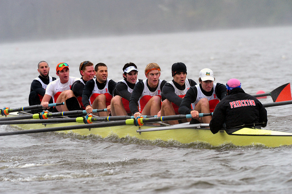 A group of people rowing a boat in the water