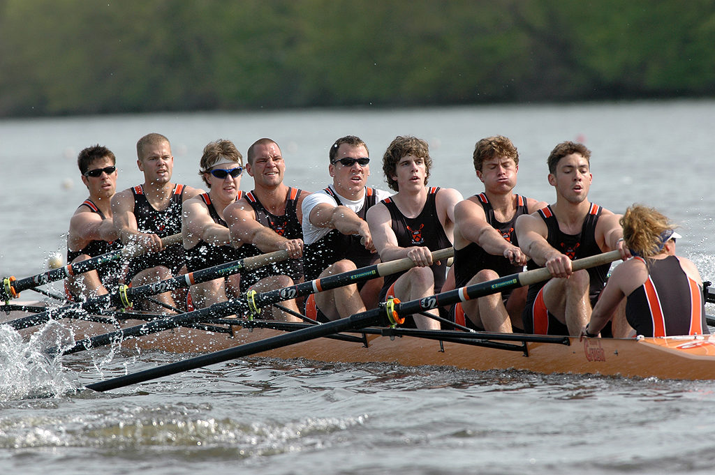 Cain Velasquez et al. rowing a boat in the water