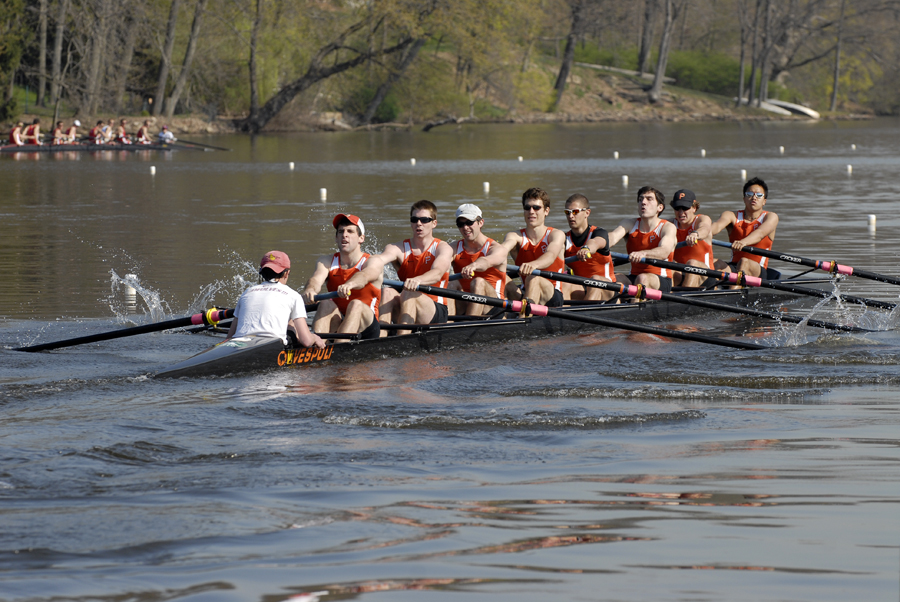 A group of people rowing a boat in the water