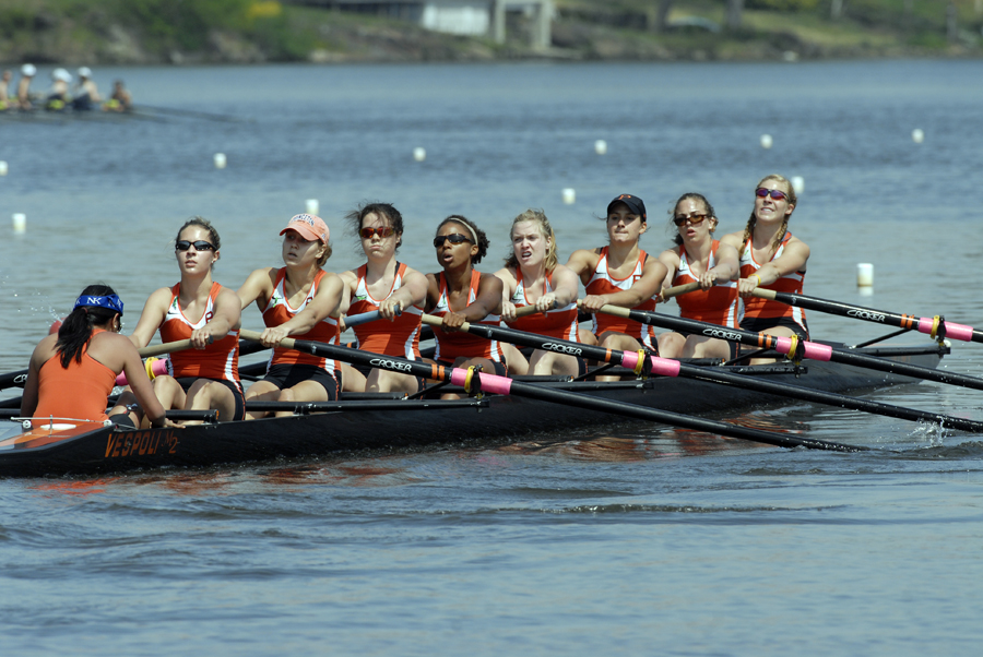 A group of people rowing a boat in the water