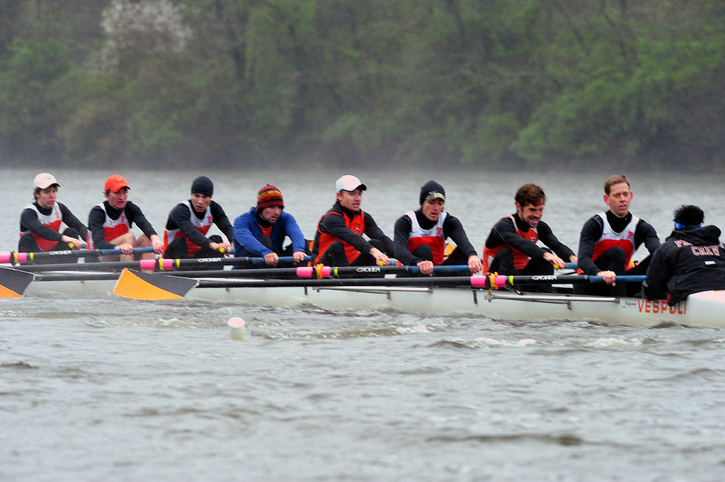 A group of people rowing a boat in the water