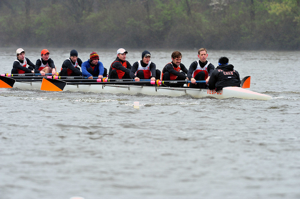 A group of people rowing a boat in the water