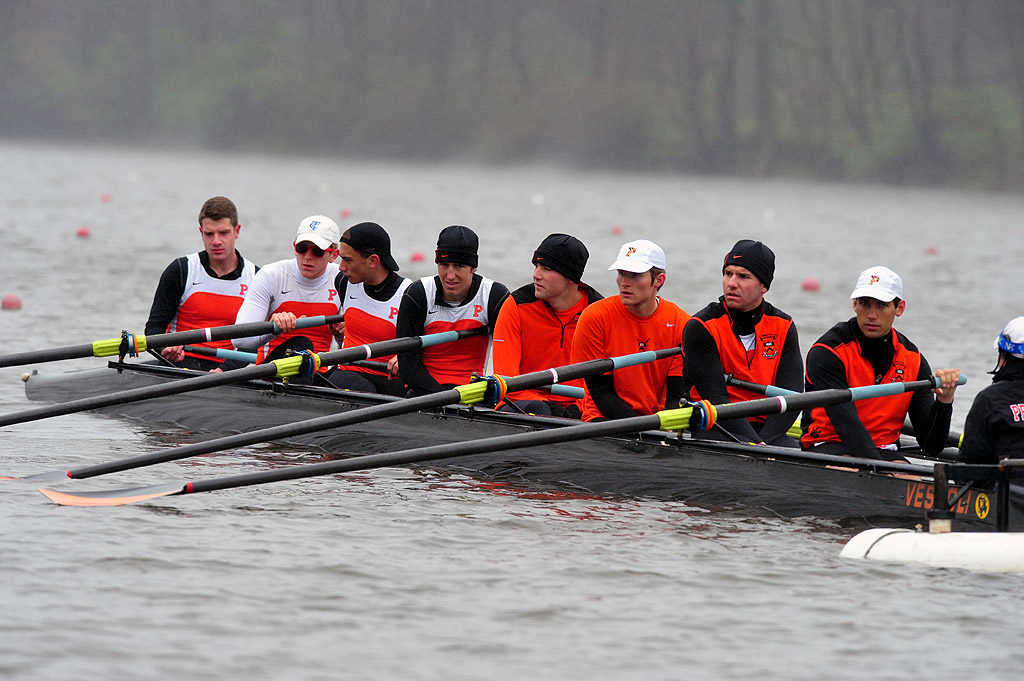 A group of people rowing a boat in the water