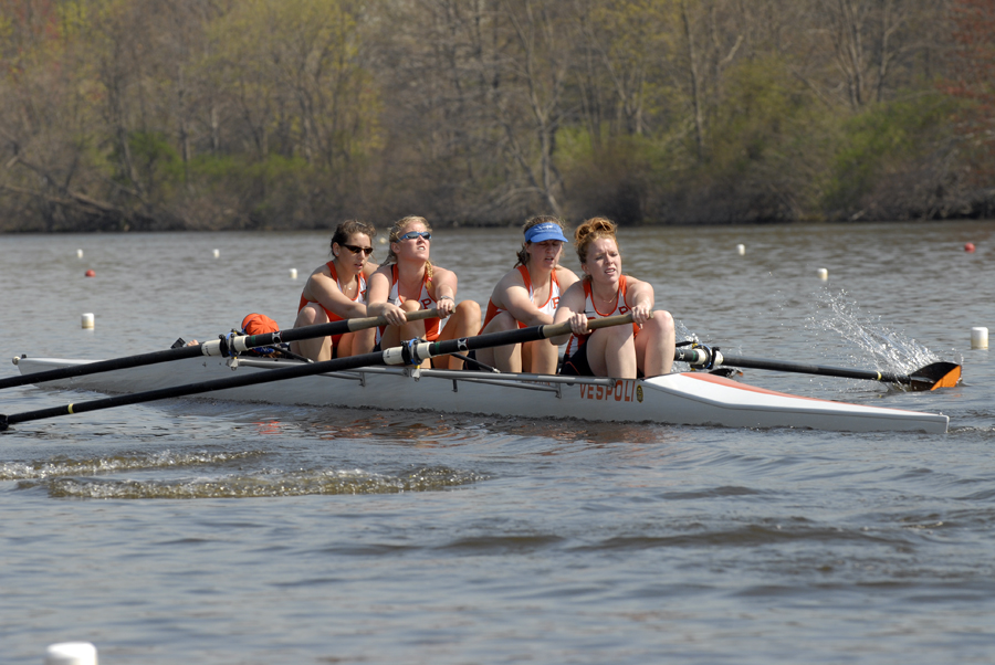 A group of people rowing a boat in the water