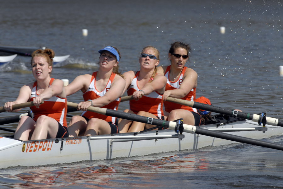 A group of people rowing a boat in the water