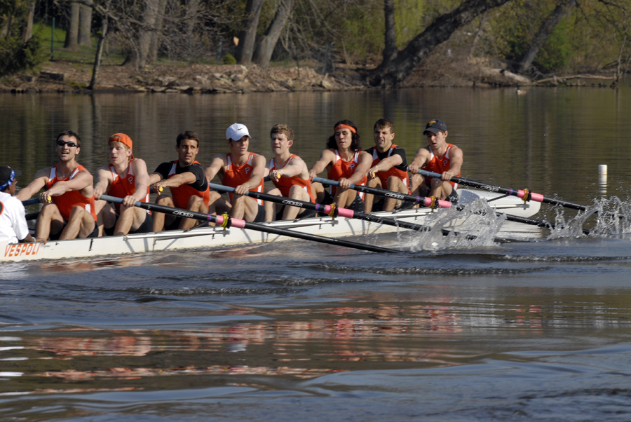 A group of people rowing a boat in the water