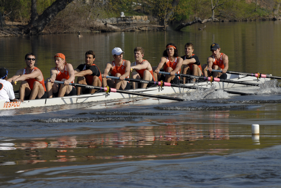 A group of people rowing a boat in the water