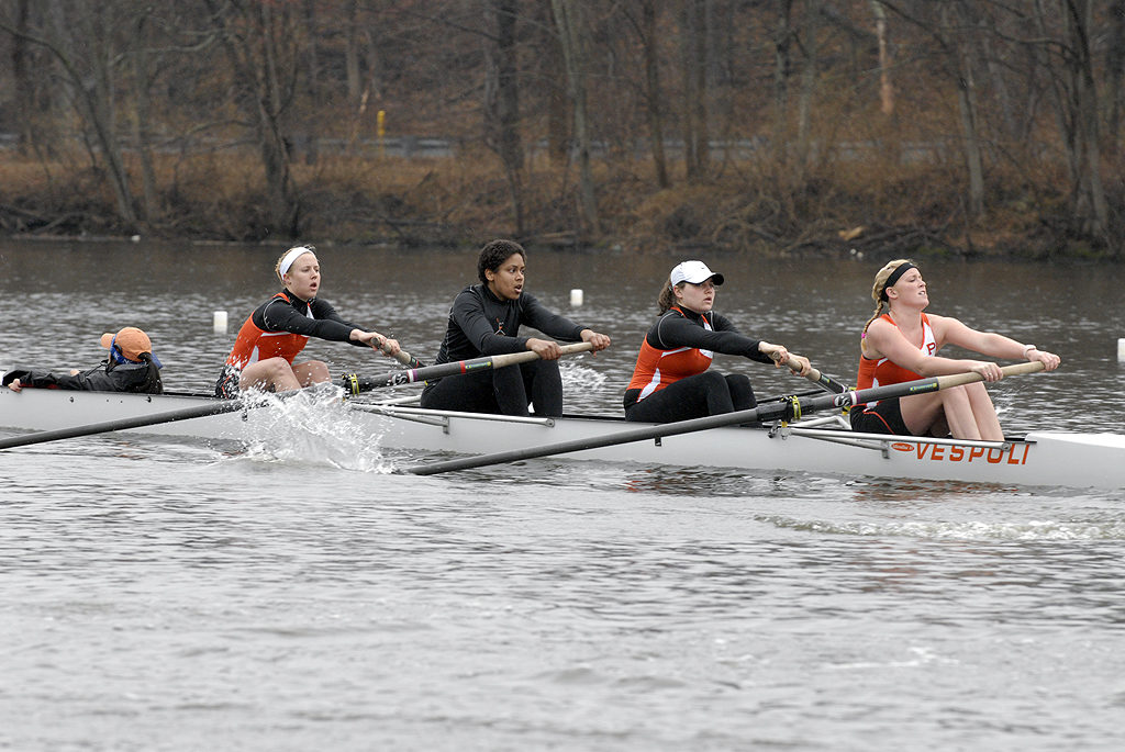 A group of people rowing a boat in the water