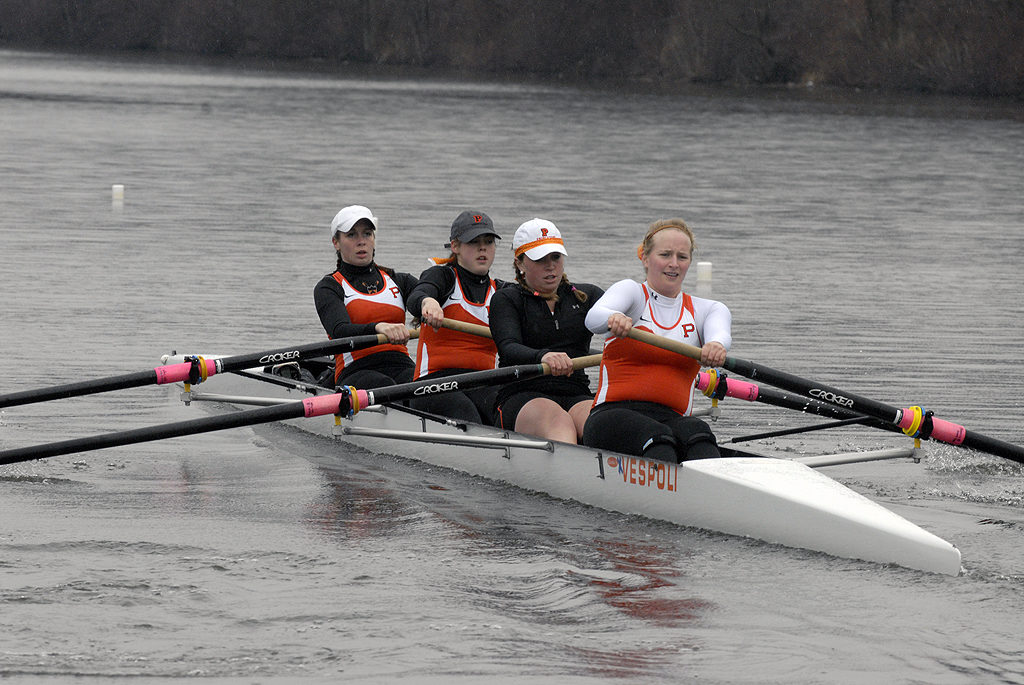 A group of people rowing a boat in the water