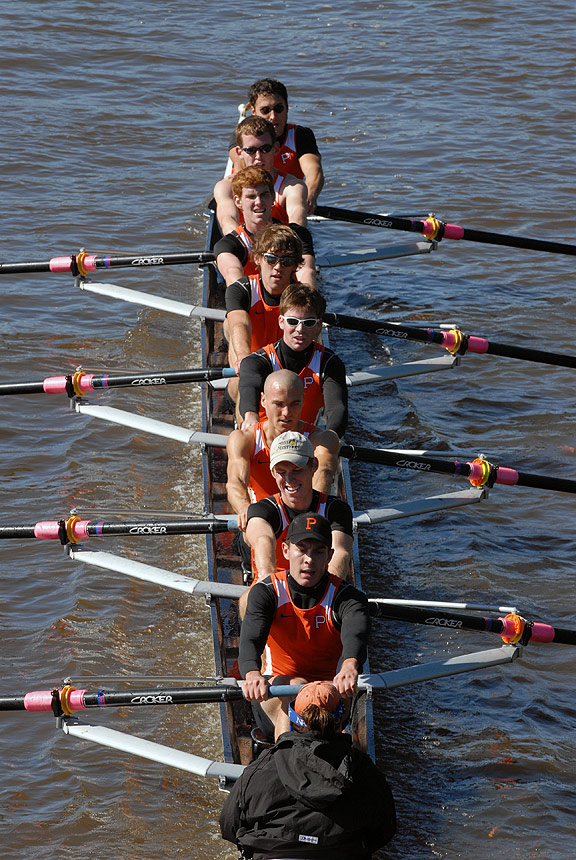 A group of people rowing a boat in the water