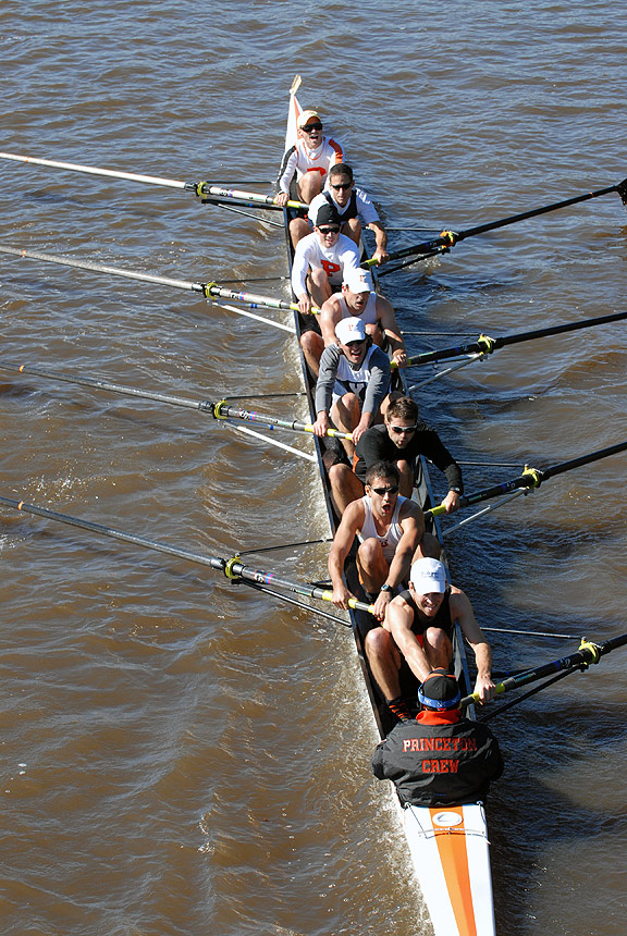 A man rowing a boat in a body of water