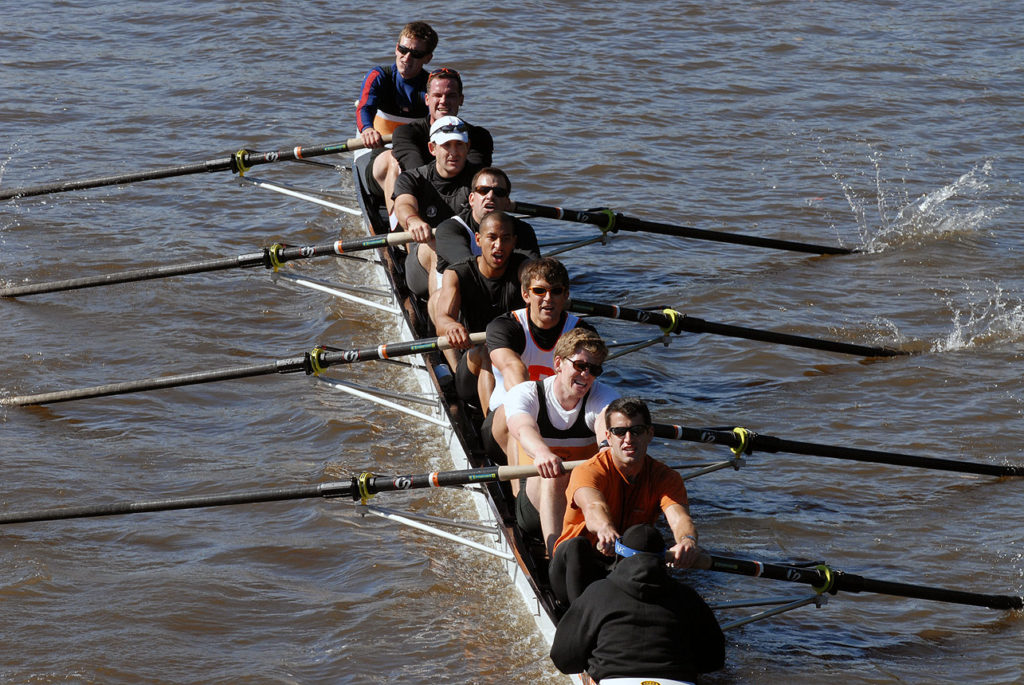 A man rowing a boat in a body of water