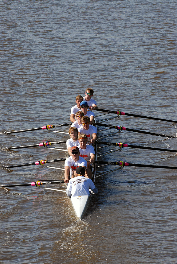 A person rowing a boat in a body of water