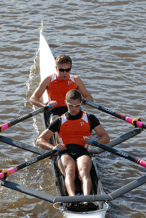 A man rowing a boat in a body of water