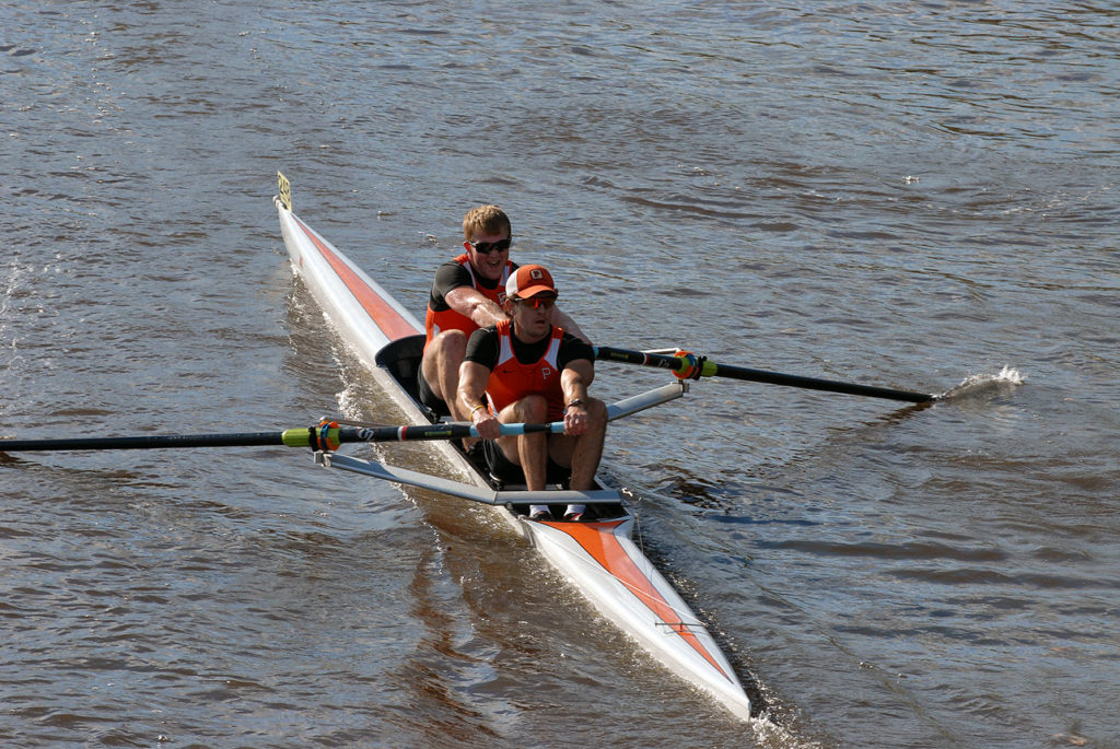 A man rowing a boat in a body of water