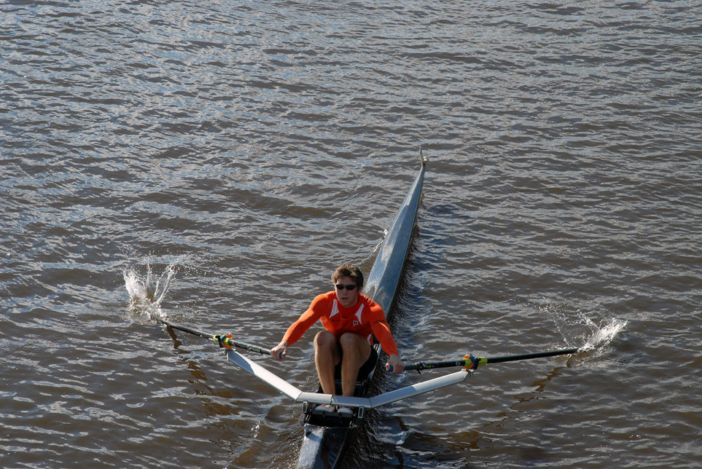 A man rowing a boat in the water