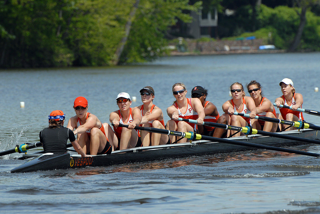 A group of people rowing a boat in the water