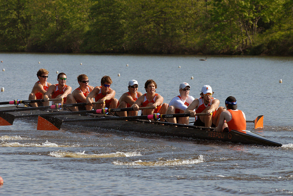 A group of people rowing a boat in the water