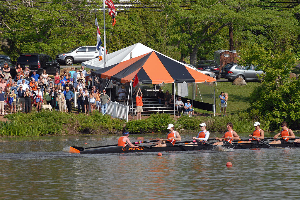 A group of people rowing a boat in the water