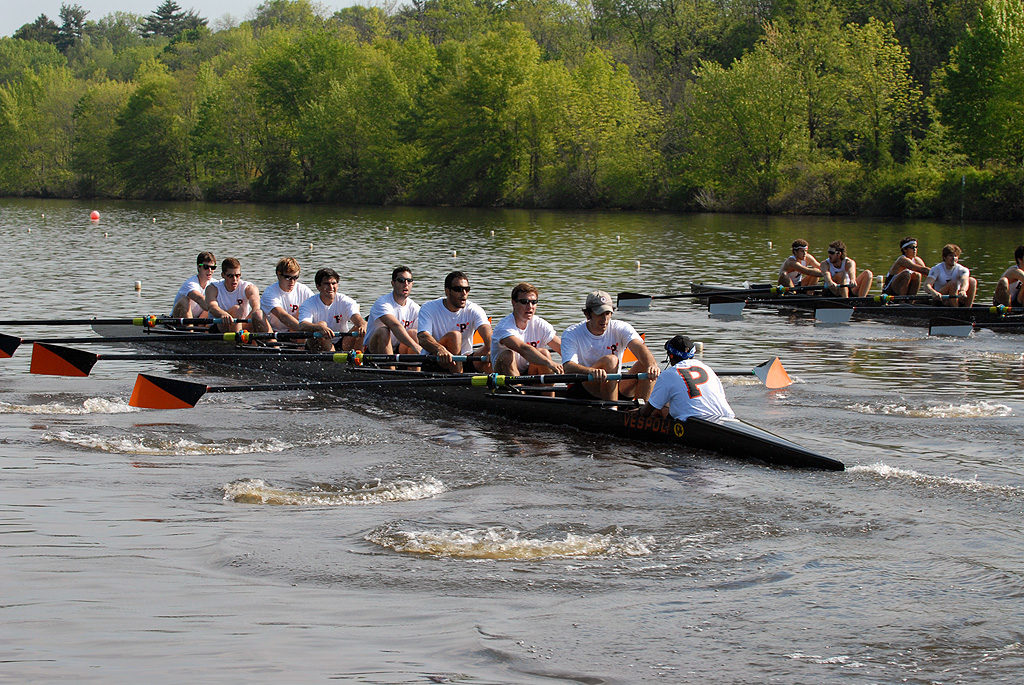 A group of people rowing a boat in the water