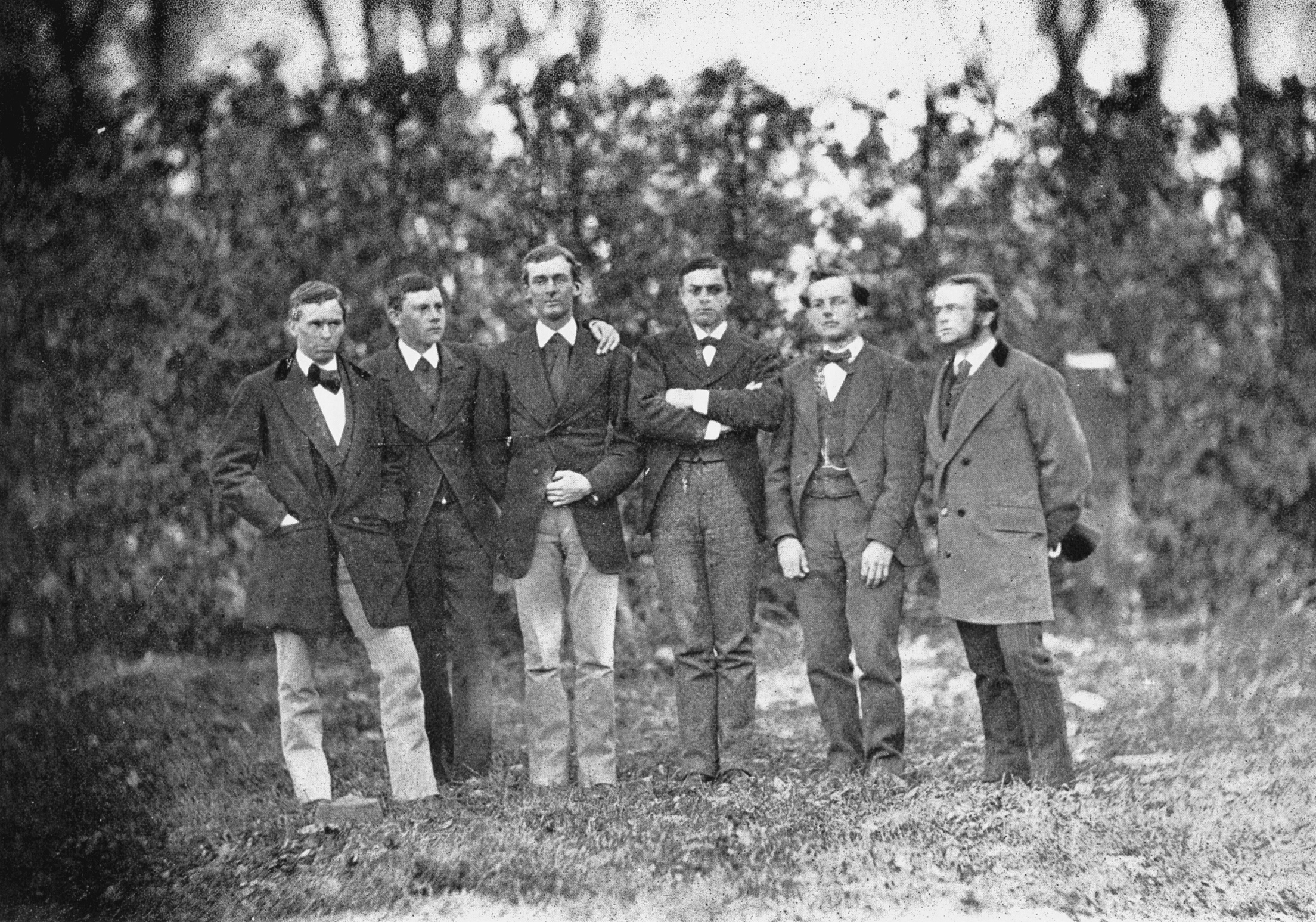 A vintage photo of a group of people posing for the camera