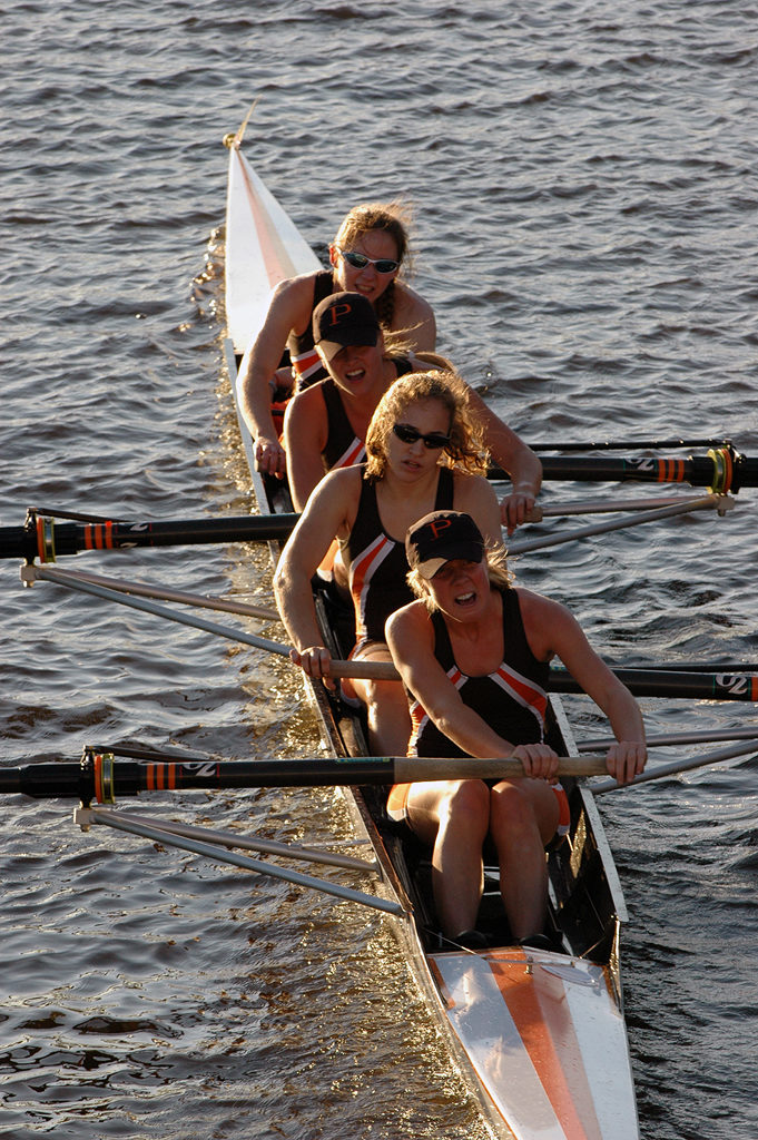 A woman rowing a boat in a body of water